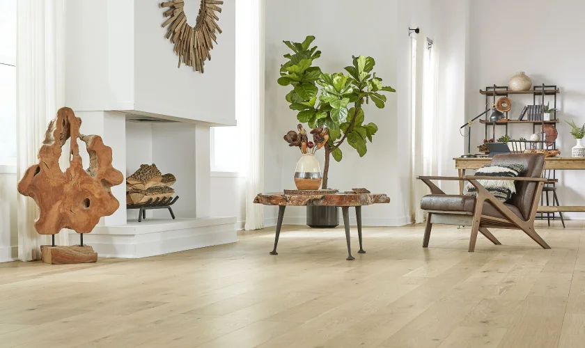 A light oak plank floor running through a bright living room with a white fireplace.